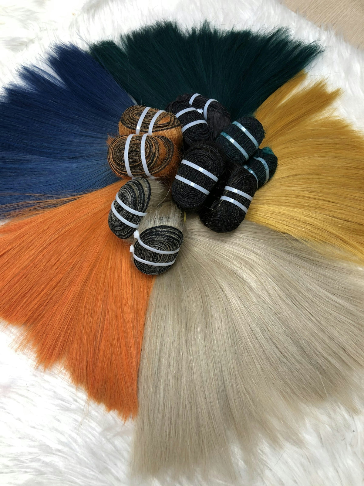a bunch of different colored hair sitting on top of each other