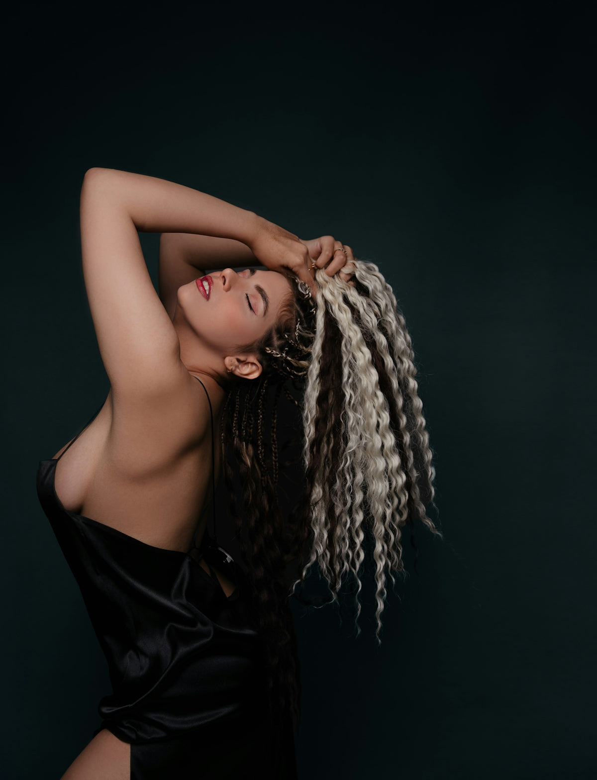 Woman with long braided hair in black dress