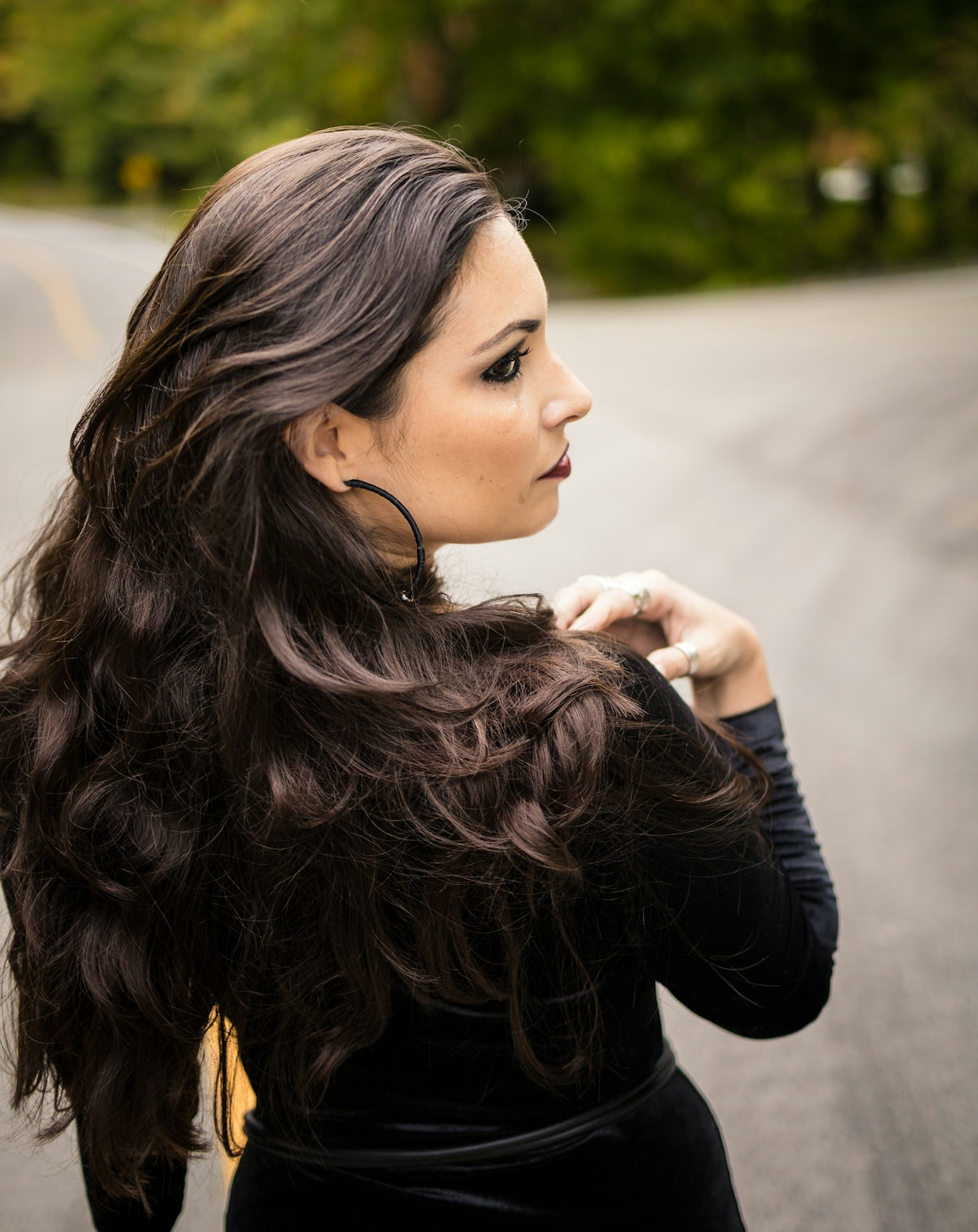 Woman with long dark hair looking over shoulder