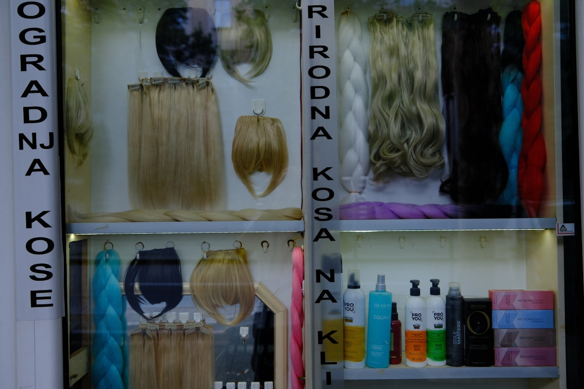 Display case filled with various hair extensions and hair products.